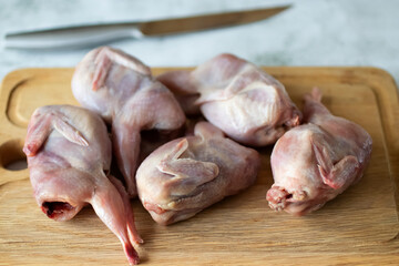 Quails on wooden board. Close-up.