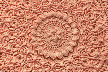 Beautiful closeup crochet doily on wooden background