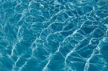 Turquoise swimming pool water, viewed from above with slight ripples