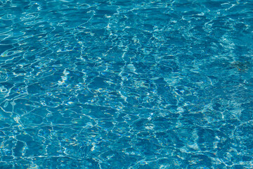 Turquoise swimming pool water, viewed from above with slight ripples