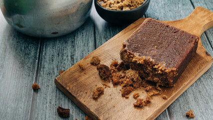 panela, from sugar cane, for different preparations on a gray background, made in Colombia.