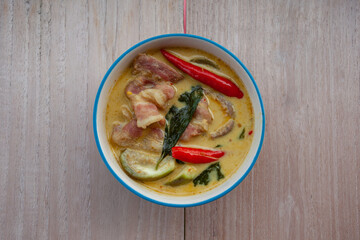 Thai food  Pork green curry on wooden floor