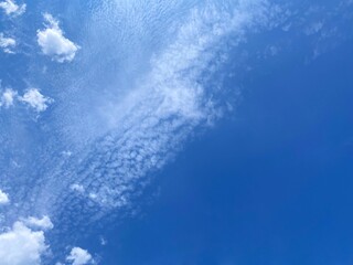 Sky clouds and sunshine. Heaven clouds background. Divine blue skies, white clouds, sun rays. Beautiful cloudscape at sunny day.