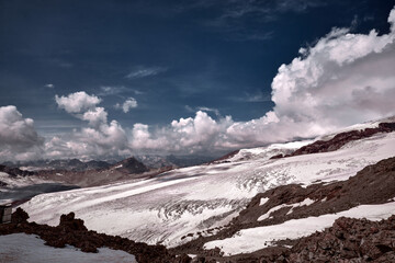 Elbrus area, Greater Caucasus Range. Elbrus, mountains in winter. Mountainous landscape, Elbrus, clouds.