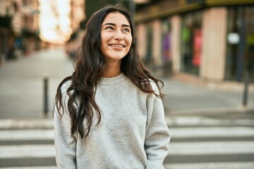Young middle east girl smiling happy standing at the city.