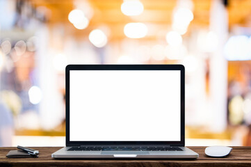 Desk Laptop with blank screen on table of coffee shop blur background