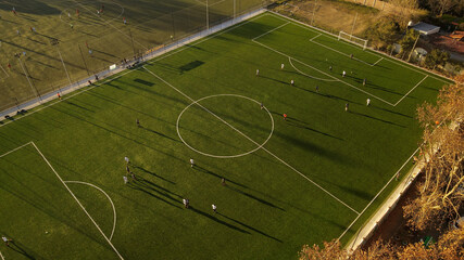 Birds eye view of players dribbling the football during championship match.