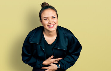 Young hispanic girl wearing sportswear smiling and laughing hard out loud because funny crazy joke...