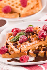 Waffles with raspberries and chocolate cream.