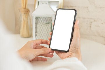 cell phone blank white screen mockup.woman hand holding texting using mobile on desk at office.background empty space for advertise.work people contact marketing business,technology