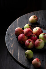 Fresh apples in bowl on wooden table