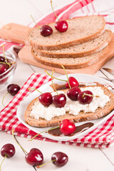 Rye bread with cottage cheese and cherries.