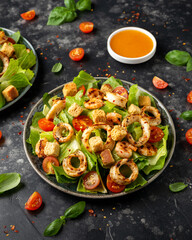 Grilled squid or calamari and shrimp salad with garlic croutons and cherry tomatoes. healthy food.