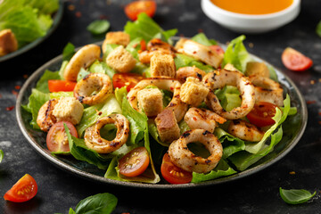 Grilled squid or calamari and shrimp salad with garlic croutons and cherry tomatoes. healthy food.