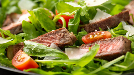 Italian Beef Tagliata salad with wild rocket, cherry tomatoes and parmesan cheese