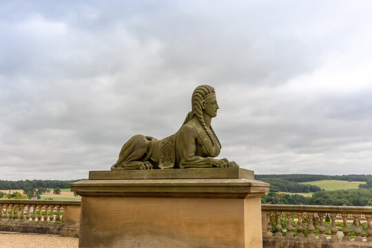 Antique stone carved sculpture of a sphinx, famous monument depicts the body of a lion with a human head in the gardens of Harewood House near Leeds.