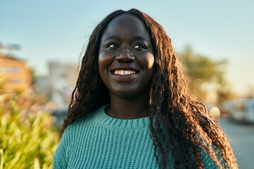 Young african woman smiling happy at the city