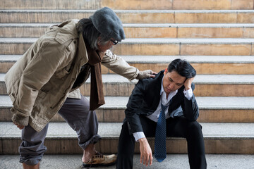 Homeless man encourage depress businessman