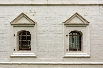 Windows of an old brick building with iron bars
