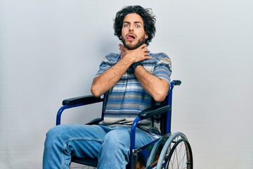 Handsome hispanic man sitting on wheelchair shouting suffocate because painful strangle. health problem. asphyxiate and suicide concept.