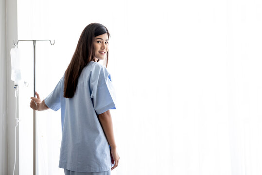 Asian attractive  woman patient, Standing, smile and holding salt water pole, to people and  health care concept.