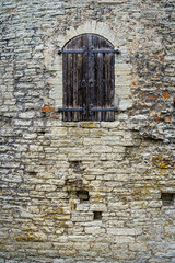 Fototapeta premium Medieval wooden door in stone castle facade.