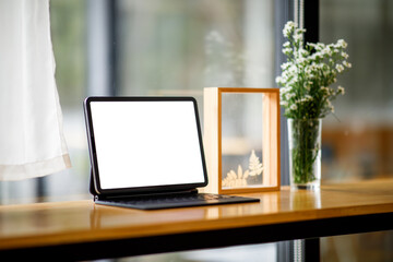 Fototapeta premium Stylish workspace with mockup tablet on table at workplace modern office.