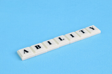 Square letters with text ABILITY isolated on a blue background