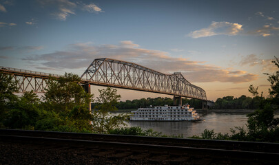 Chester, IL Bridge at sunset on the Mississippi River with a Paddle boat.