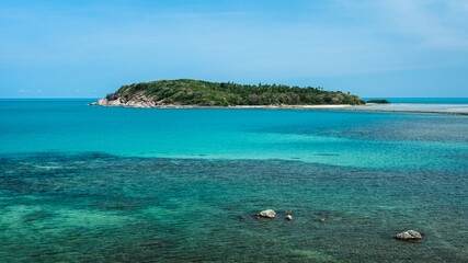 Koh Samui Island, Thailand. Scenic high angle view of a small island in crystal clear turquoise and coral reef see through sea water in summer. Minimal Background with copy space.