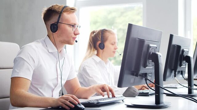 Diverse team of professionals is working in the phone support office. Working day of sales managers in the call center. Concept of business, telephone consulting and problem solving.