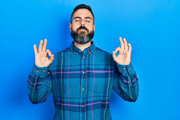 Young hispanic man wearing casual clothes relax and smiling with eyes closed doing meditation gesture with fingers. yoga concept.