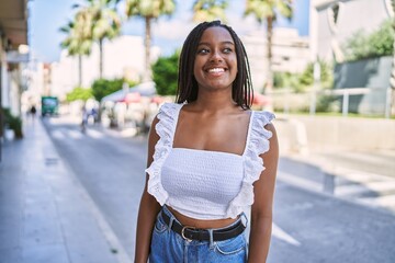 Young african american girl smiling happy standing at the city.