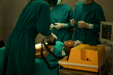 The medical team and nurses  defibrillating male patient in the operating room . group of surgeon work in surgery room