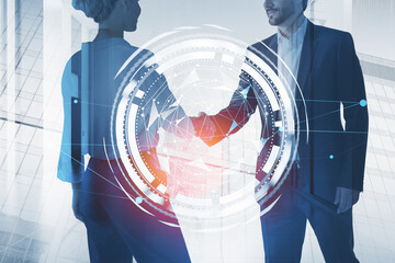 Businessman wearing formal suit shakes hands with businesswoman