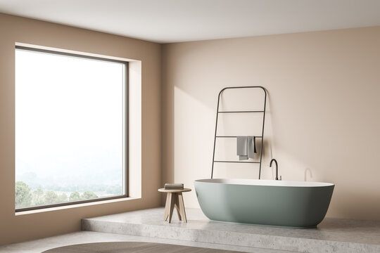 Beige And Grey Bathroom Area With A Green Bathtub. Corner View.