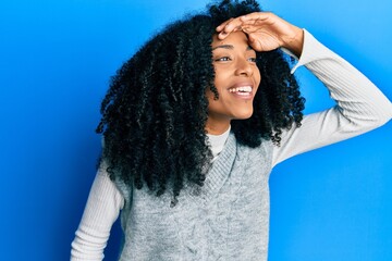 African american woman with afro hair wearing casual winter sweater very happy and smiling looking...