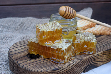 Fresh honeycombs. Fresh honey flows down on the table.