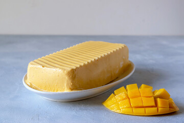 Homemade ice cream with mango on a gray background.