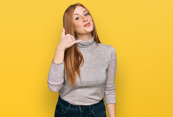 Young irish woman wearing casual clothes smiling doing phone gesture with hand and fingers like talking on the telephone. communicating concepts.