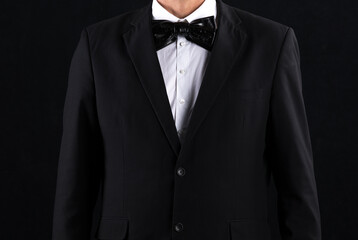 gentleman in black suit and bow tie