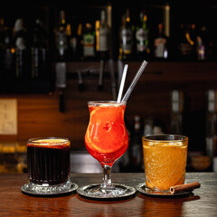 Assorted hot drinks as mulled wine, grog and ginger tea in glass cups placed in row on wooden...