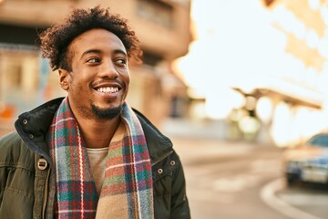 Young african american man smiling happy standing at the city