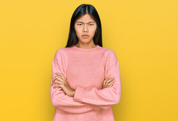 Beautiful young asian woman wearing casual winter sweater skeptic and nervous, disapproving...