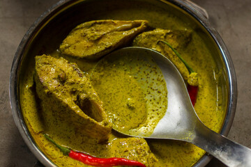 Sorshe Illish or Hilsa fish cooking with mustard seed.famous Bengali food.