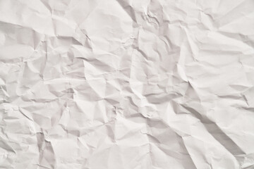 White crumpled paper texture with wrinkles. Damaged and torn sheet