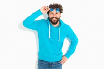 casual sexy guy moving his sunglasses on his forehead