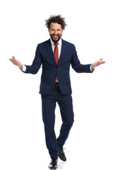 handsome businessman walking towards the camera with open arms