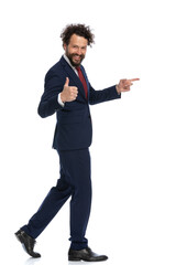 young businessman walking and pointing to side