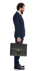 businessman waiting in line while holding a briefcase